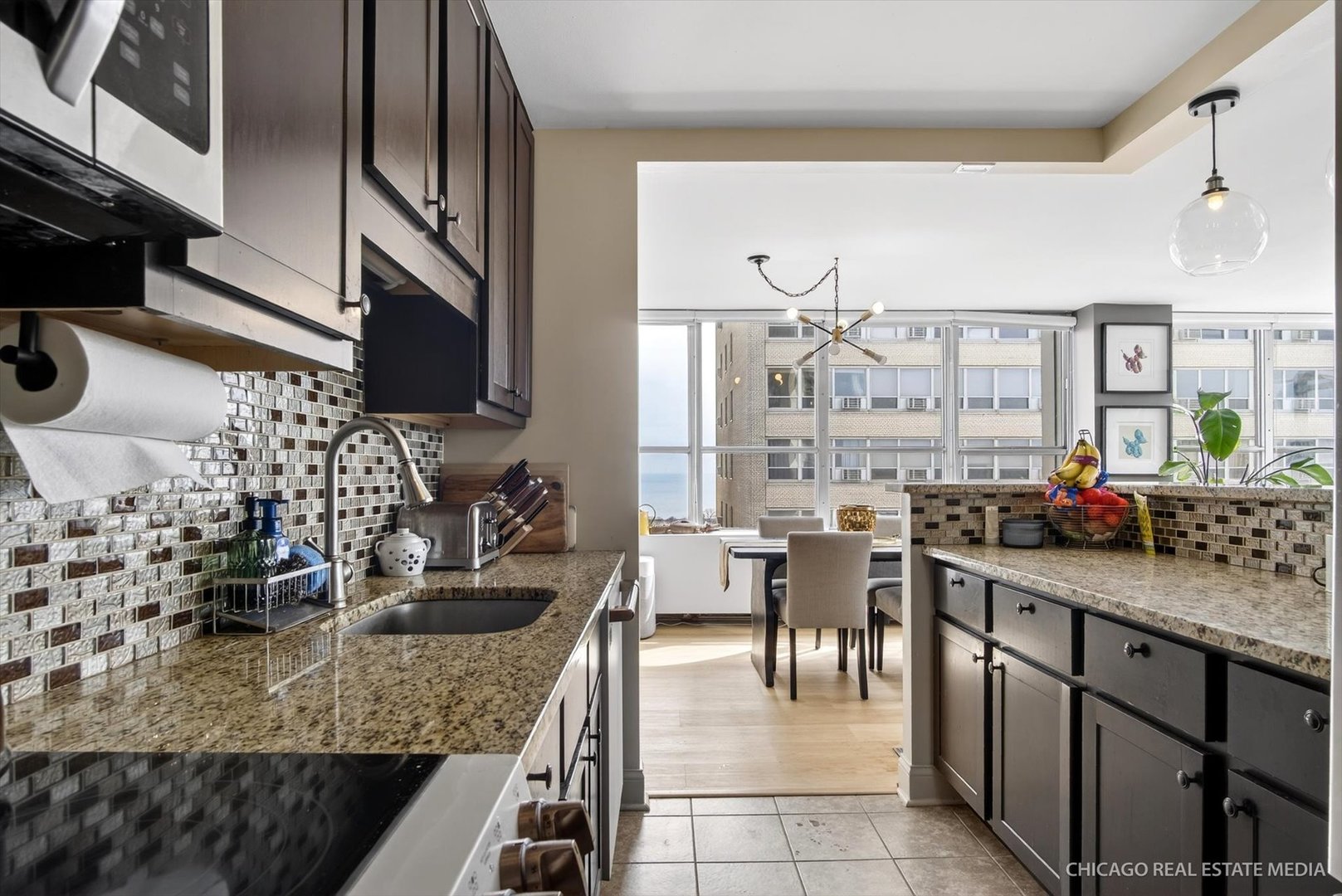 655 West Irving Park Road, Unit 1101 Chicago, IL 60613 - Photo 14 of 26 a kitchen with counter top space cabinets and stainless steel appliances