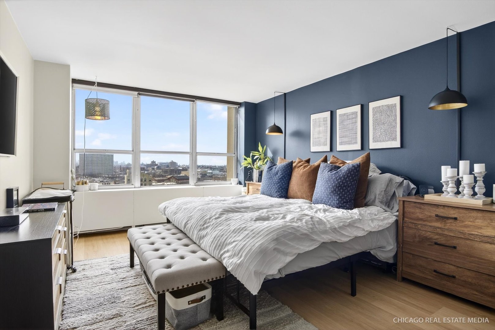 655 West Irving Park Road, Unit 1101 Chicago, IL 60613 - Photo 16 of 26 a bedroom with a bed and wooden floor