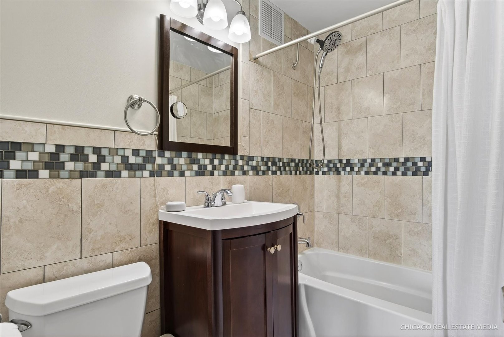 655 West Irving Park Road, Unit 1101 Chicago, IL 60613 - Photo 21 of 26 a bathroom with a sink a toilet and shower