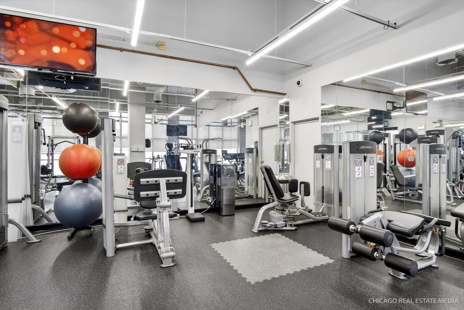 655 West Irving Park Road, Unit 1101 Chicago, IL 60613 - Photo 25 of 26 a view of a room with gym equipment