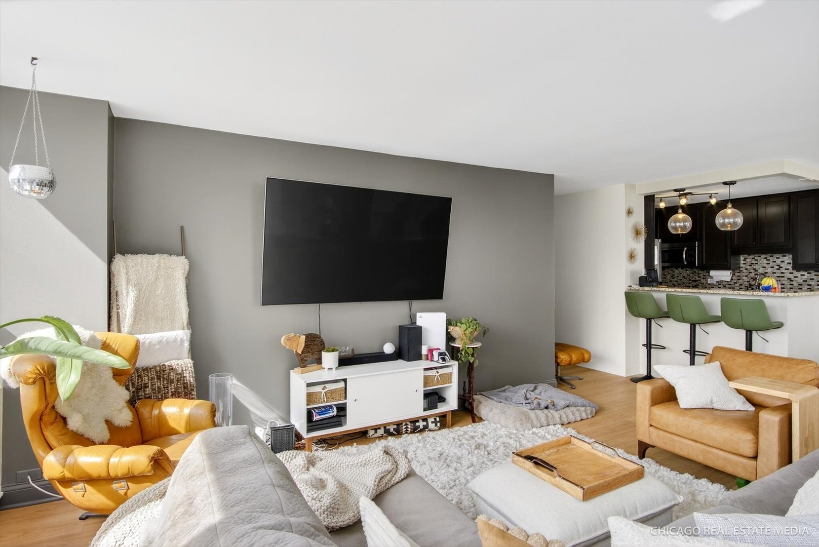 655 West Irving Park Road, Unit 1101 Chicago, IL 60613 - Photo 8 of 26 a living room with furniture and a flat screen tv