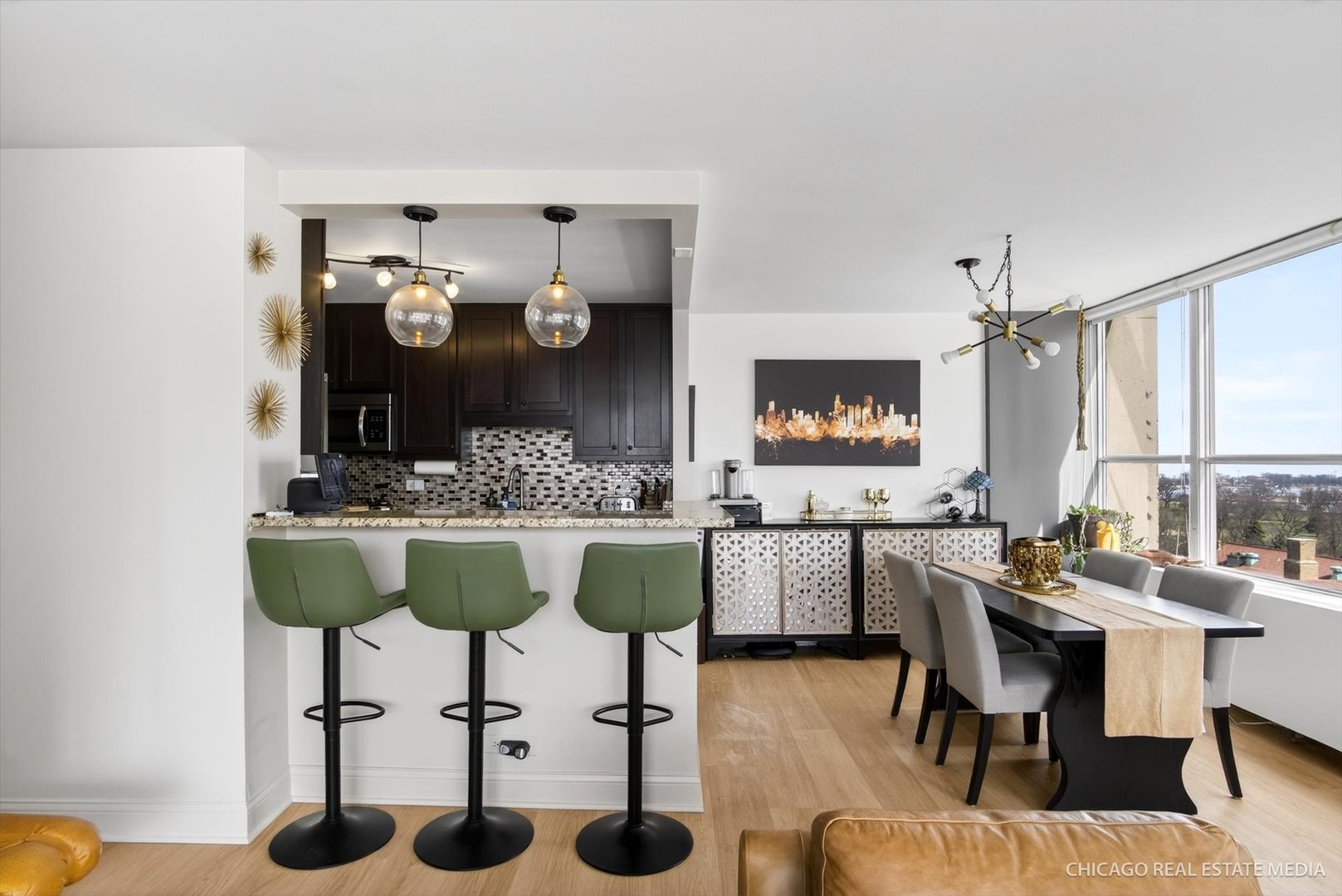 655 West Irving Park Road, Unit 1101 Chicago, IL 60613 - Photo 10 of 26 a kitchen with a dining table and chairs