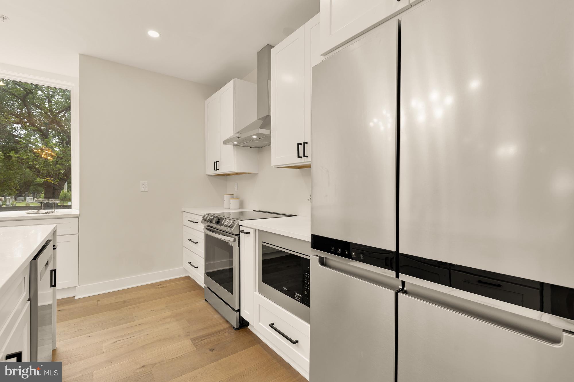 1631 G Street Southeast Washington, DC 20003 - Photo 12 of 42 a kitchen with stainless steel appliances a refrigerator and a stove