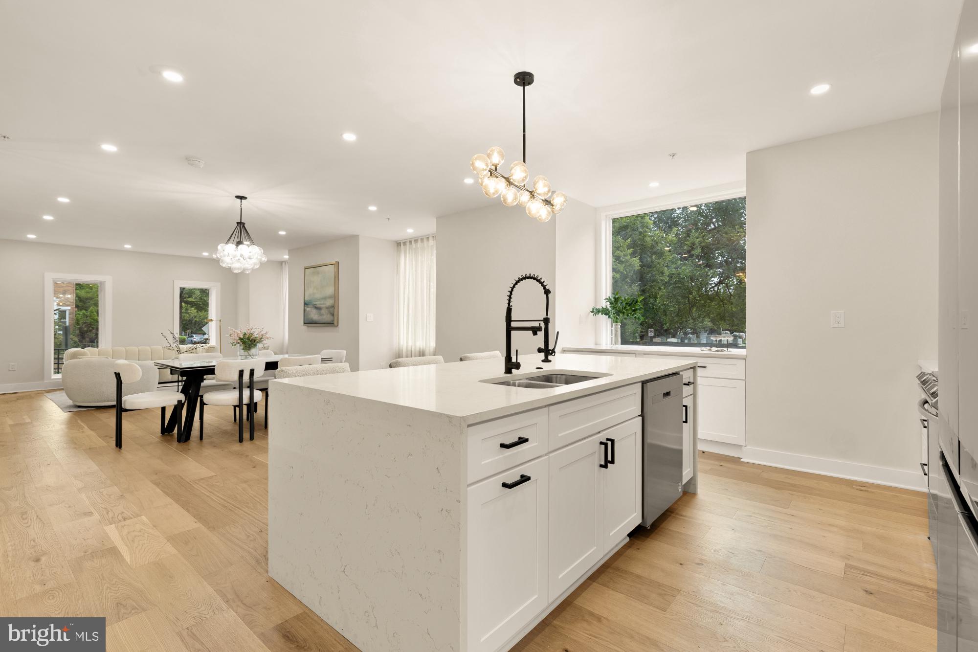 1631 G Street Southeast Washington, DC 20003 - Photo 13 of 42 a large white kitchen with a large island oven a stove and a wooden floors