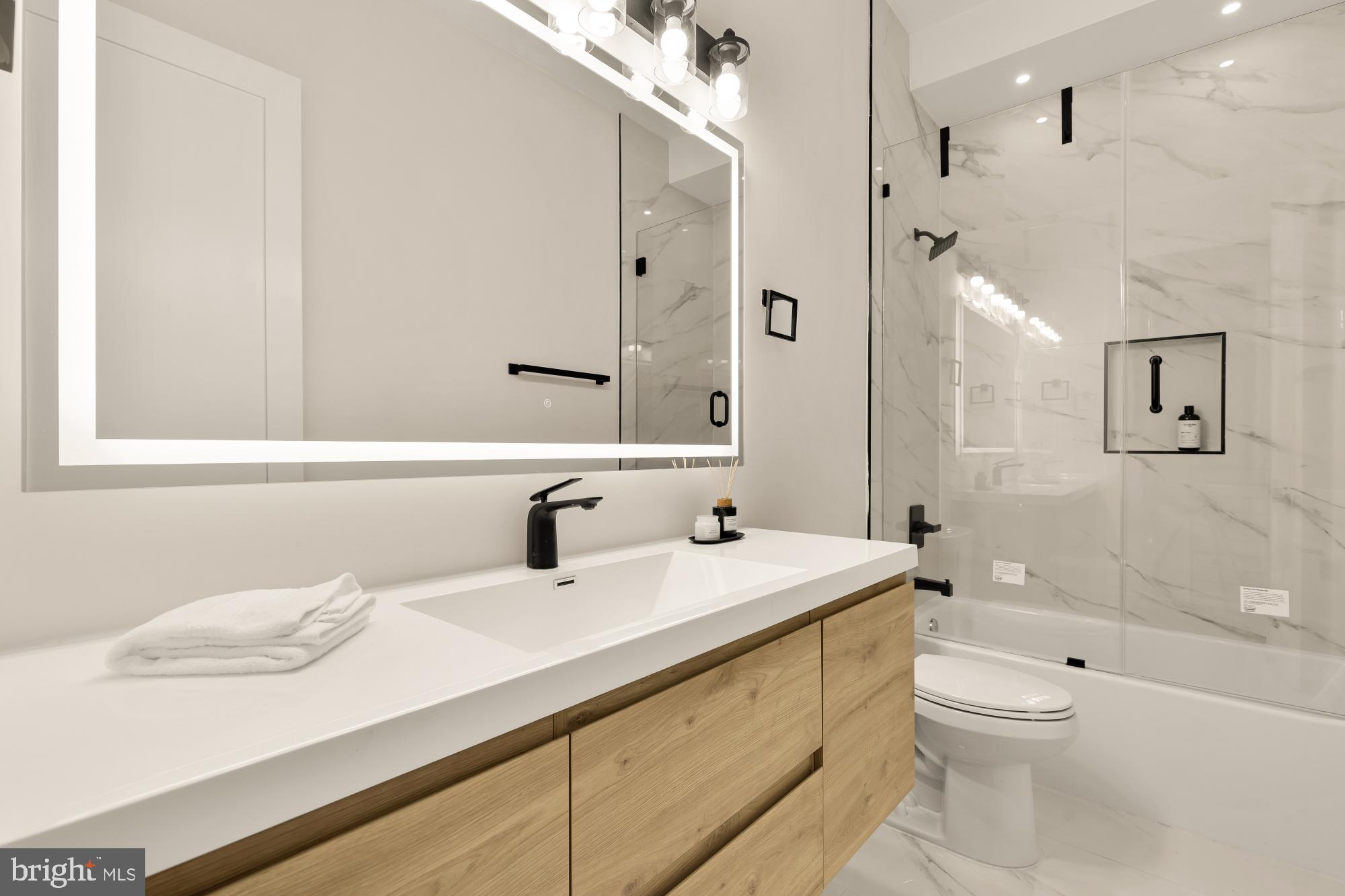 1631 G Street Southeast Washington, DC 20003 - Photo 18 of 42 a bathroom with a sink a toilet and shower