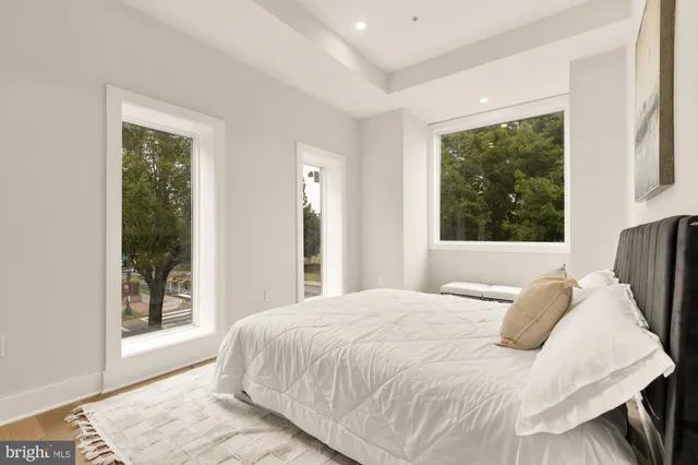 a bedroom with a large bed and a large window