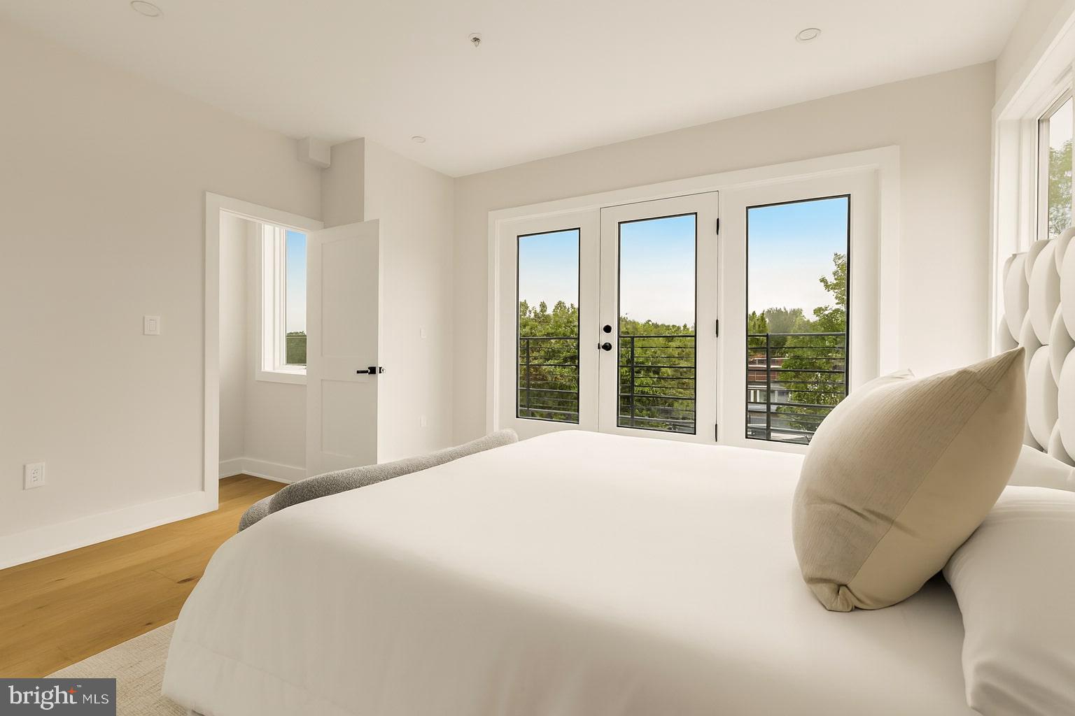 1631 G Street Southeast Washington, DC 20003 - Photo 26 of 42 a bedroom with a bed and large windows