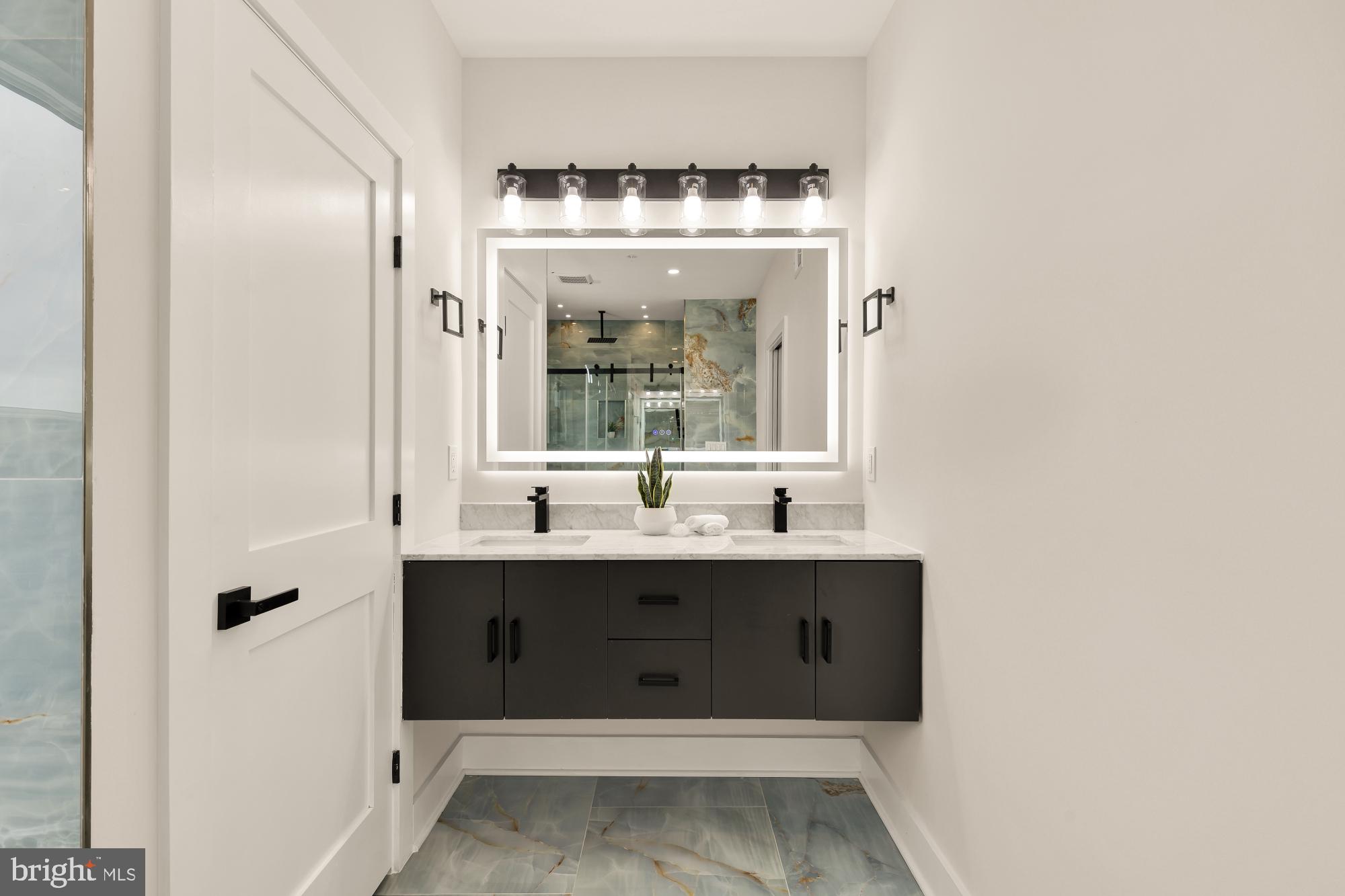 1631 G Street Southeast Washington, DC 20003 - Photo 34 of 42 a view of a bathroom with a sink and mirror