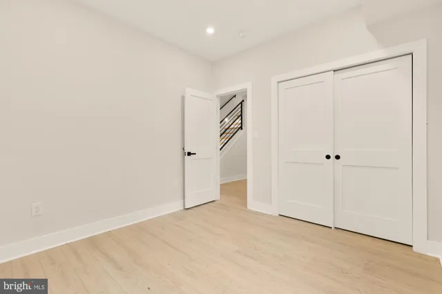 a bathroom with a granite countertop toilet sink mirror and