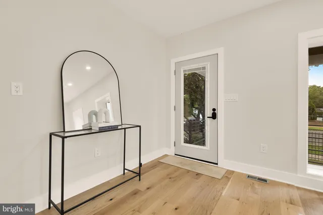 a view of an entryway with wooden floor
