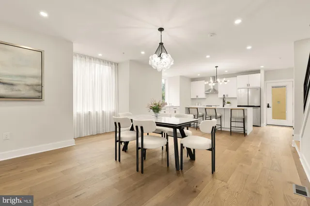 a dining room with furniture and wooden floor
