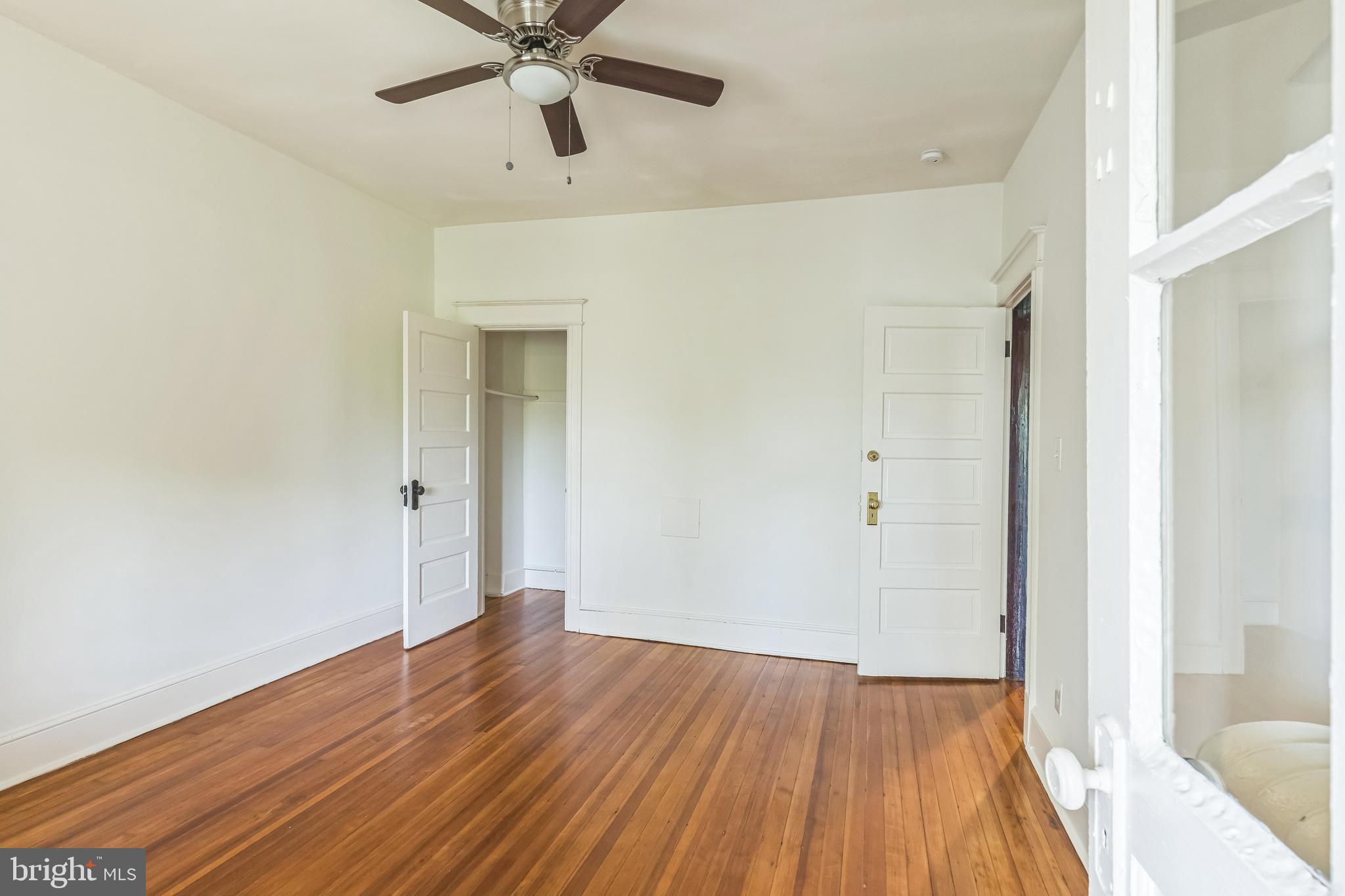 522 Randolph Street Northwest, Unit 1 Washington, DC 20011 - Photo 19 of 33 a view of an empty room with wooden floor and a window