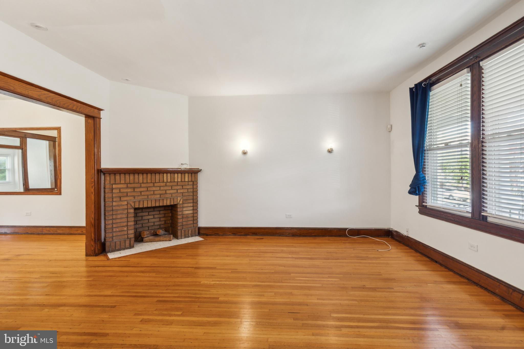 522 Randolph Street Northwest, Unit 1 Washington, DC 20011 - Photo 3 of 33 a view of empty room with wooden floor and fireplace