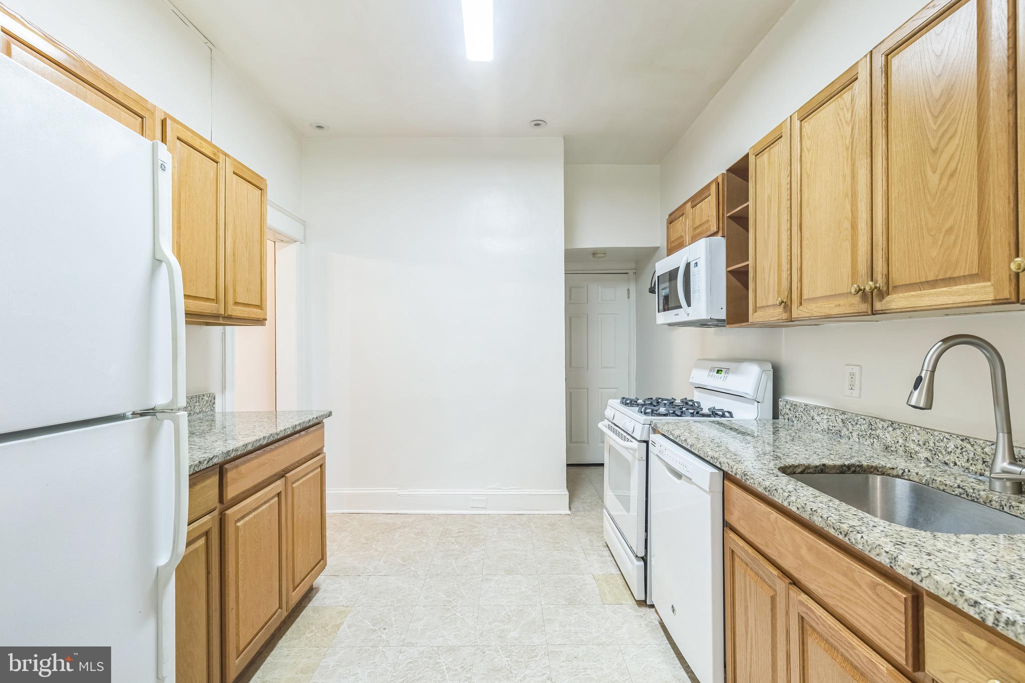 522 Randolph Street Northwest, Unit 1 Washington, DC 20011 - Photo 4 of 33 a kitchen with a sink a stove and cabinets