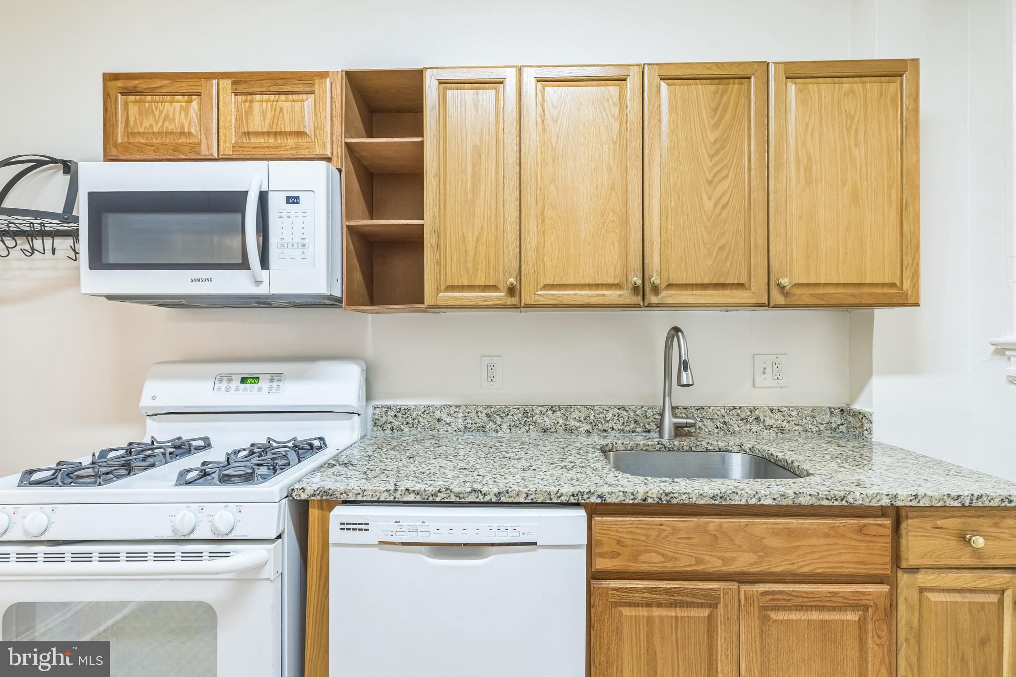 522 Randolph Street Northwest, Unit 1 Washington, DC 20011 - Photo 5 of 33 a kitchen with granite countertop cabinets stainless steel appliances and a counter space