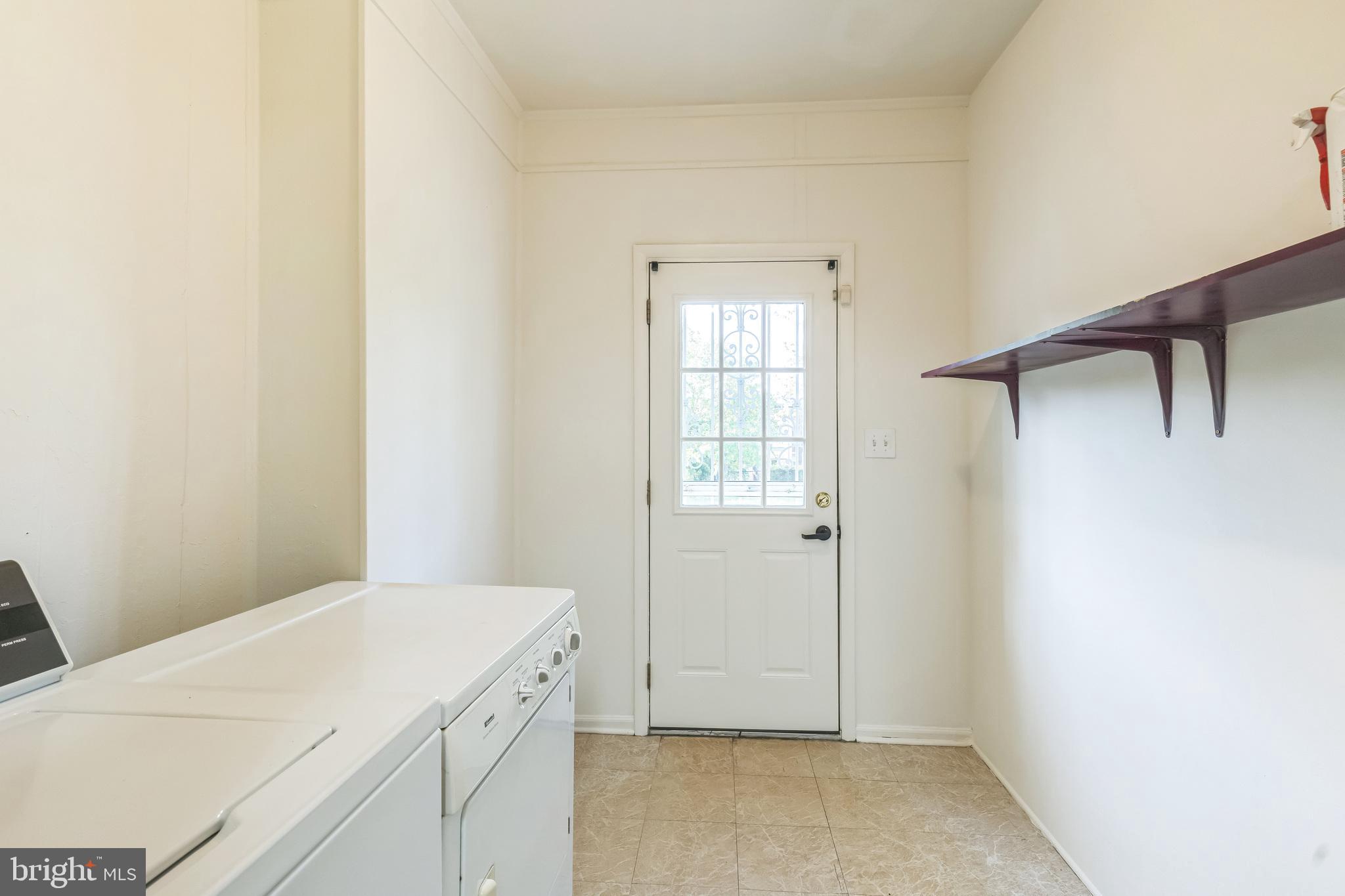 522 Randolph Street Northwest, Unit 1 Washington, DC 20011 - Photo 6 of 33 a room with a white bed and a window