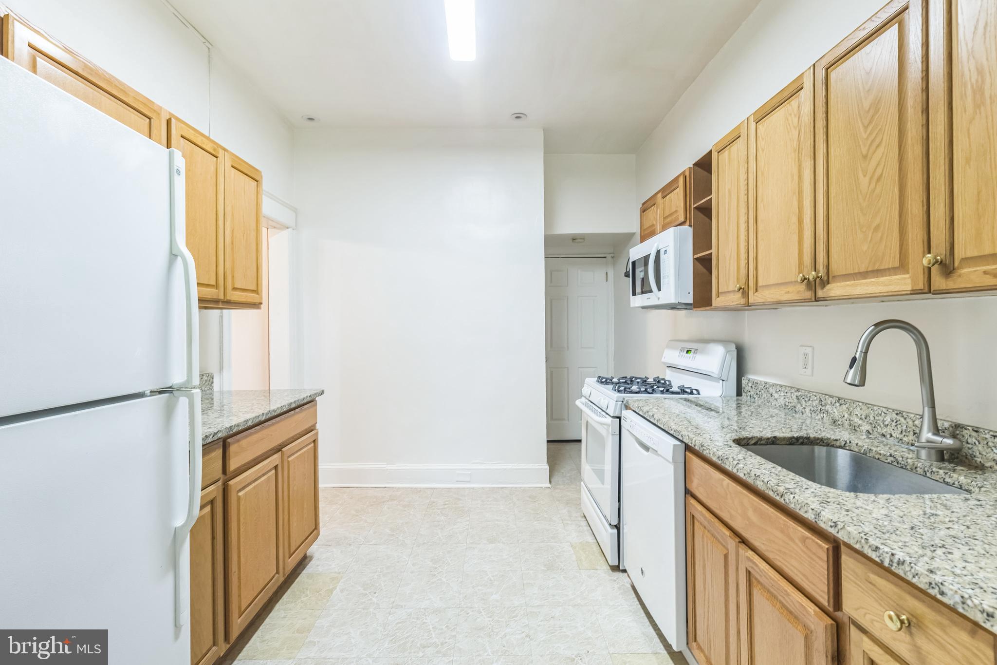 522 Randolph Street Northwest, Unit 1 Washington, DC 20011 - Photo 8 of 33 a kitchen with stainless steel appliances granite countertop a sink a stove and refrigerator