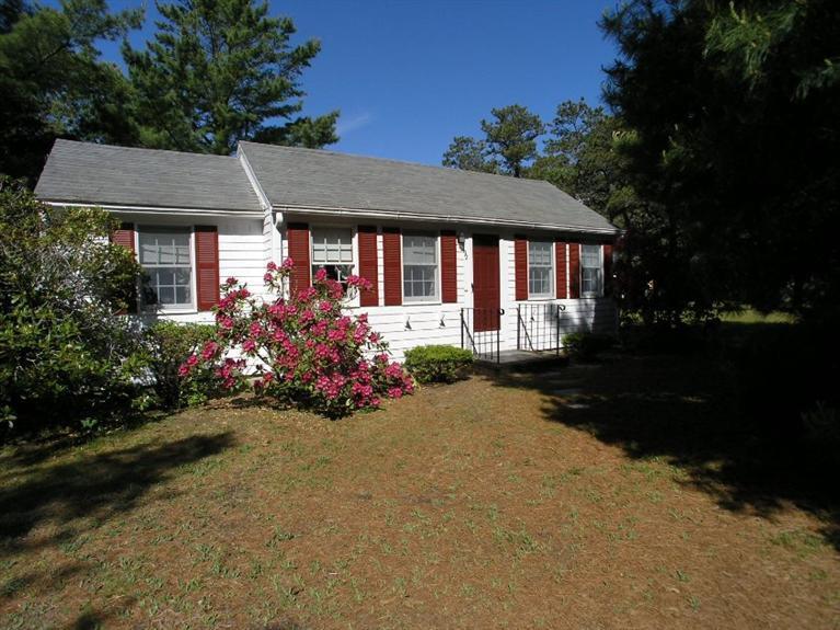 92 Earle Road West Harwich, MA 02671 - Photo 1 of 19 a front view of a house with a yard and garden