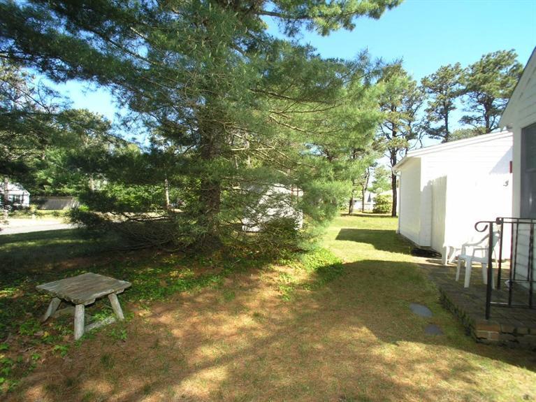 92 Earle Road West Harwich, MA 02671 - Photo 17 of 19 a backyard of a house with table and chairs