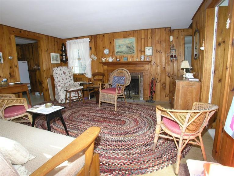 92 Earle Road West Harwich, MA 02671 - Photo 6 of 19 a living room with furniture a rug and a large window
