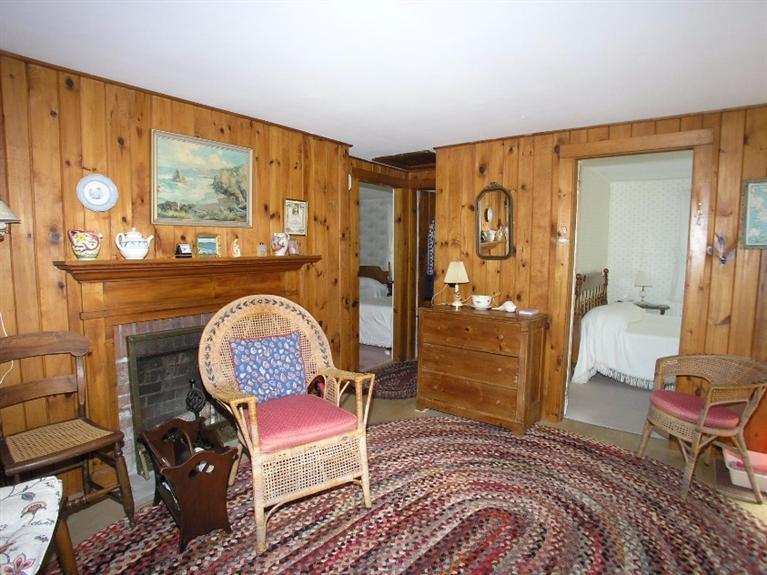92 Earle Road West Harwich, MA 02671 - Photo 9 of 19 a bedroom with a bed and dresser with wooden floor