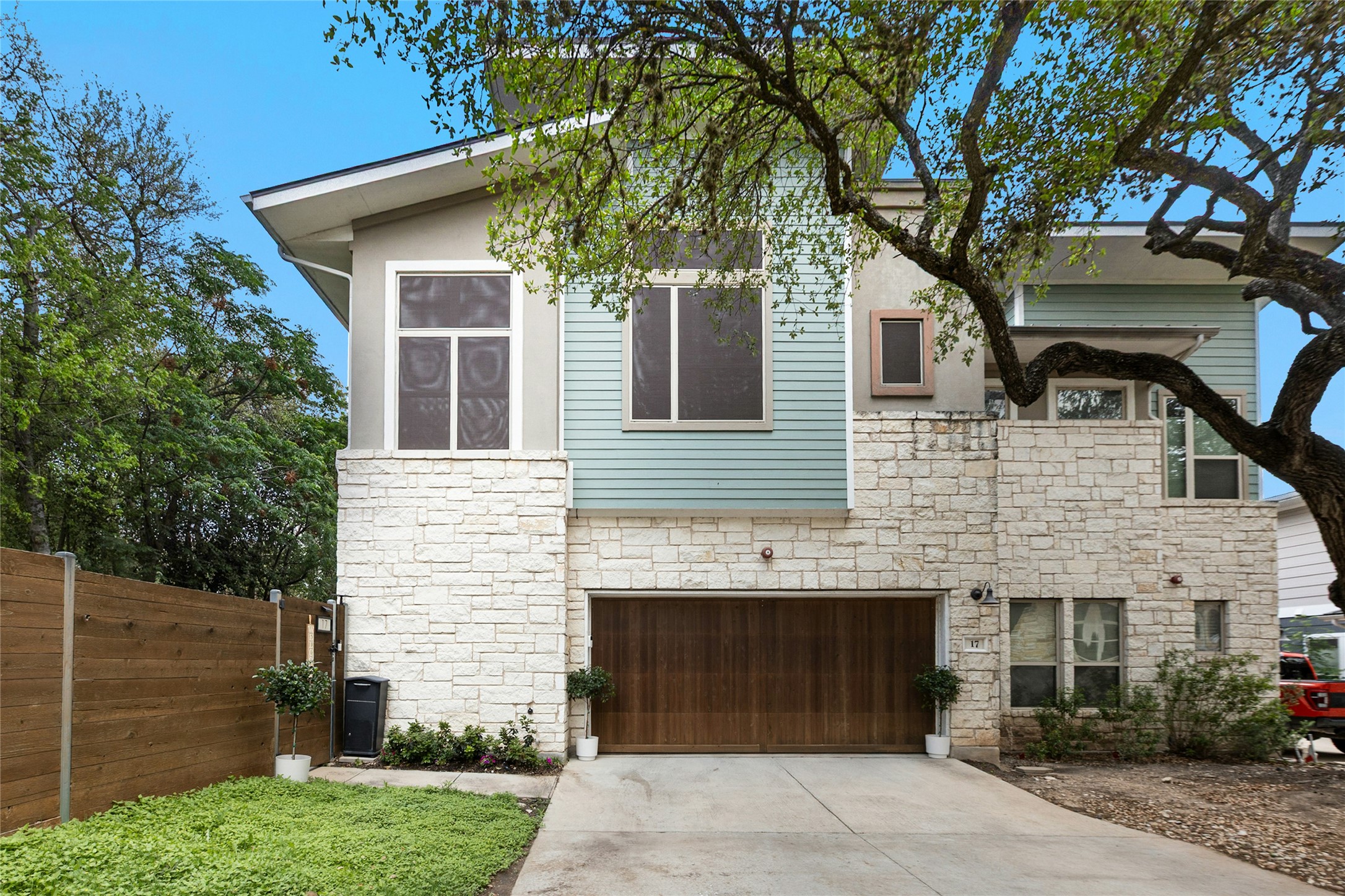 Contemporary facade featuring stone veneer and horizontal siding