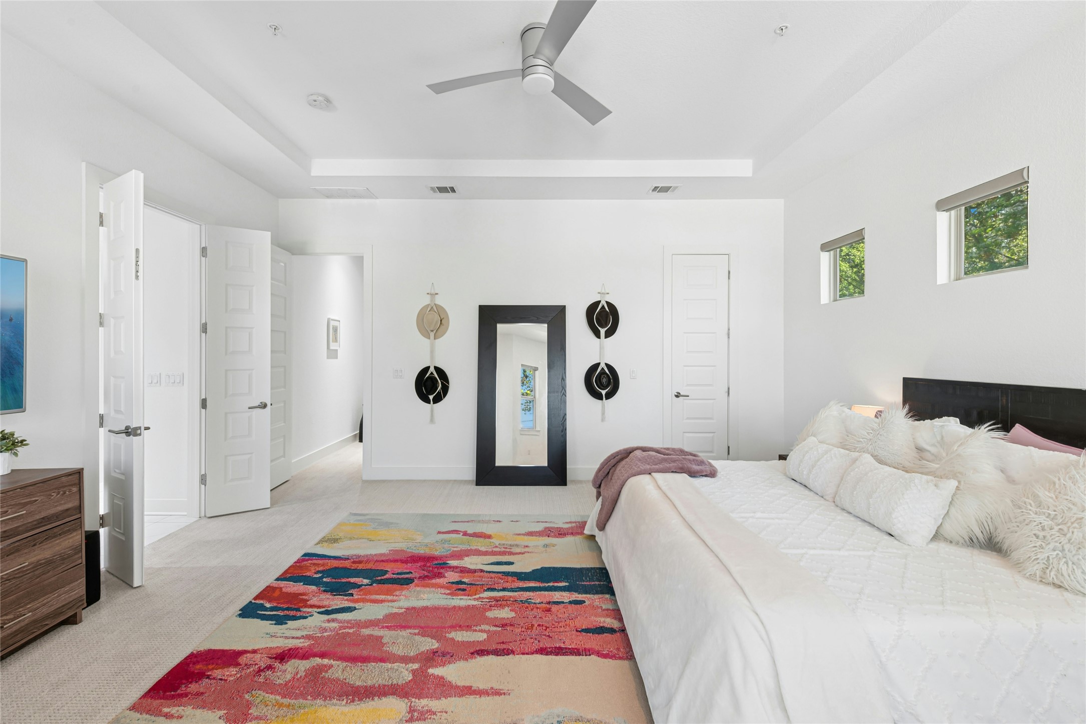404 West Alpine Road, Unit 17 Austin, TX 78704 - Photo 26 of 35 Bedroom featuring a tray ceiling, light colored carpet, and ceiling fan