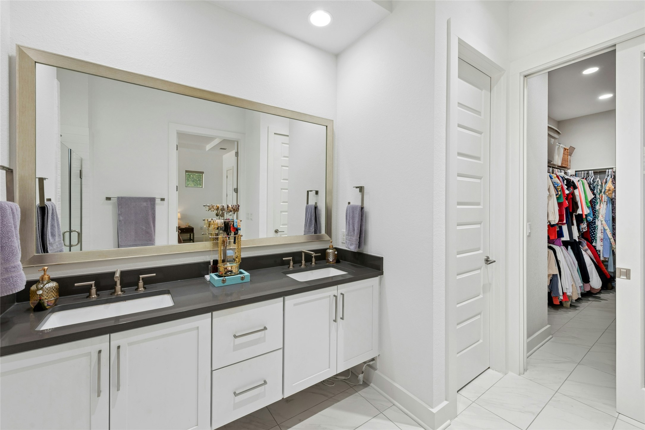 404 West Alpine Road, Unit 17 Austin, TX 78704 - Photo 27 of 35 Bathroom with double vanity, a spacious closet, and recessed lighting