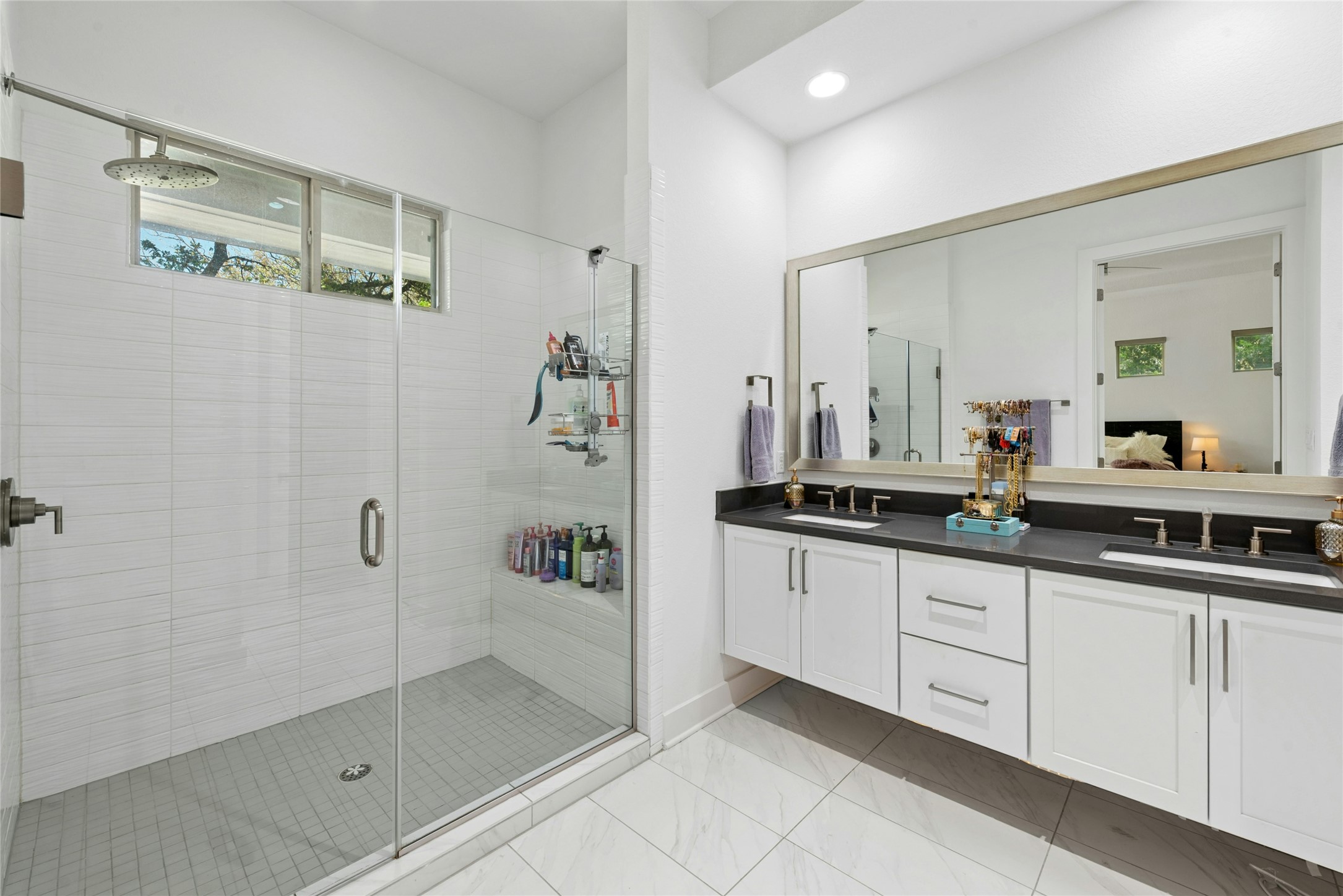 404 West Alpine Road, Unit 17 Austin, TX 78704 - Photo 28 of 35 Ensuite bathroom featuring double vanity, a shower stall, recessed lighting, and light marble finish flooring