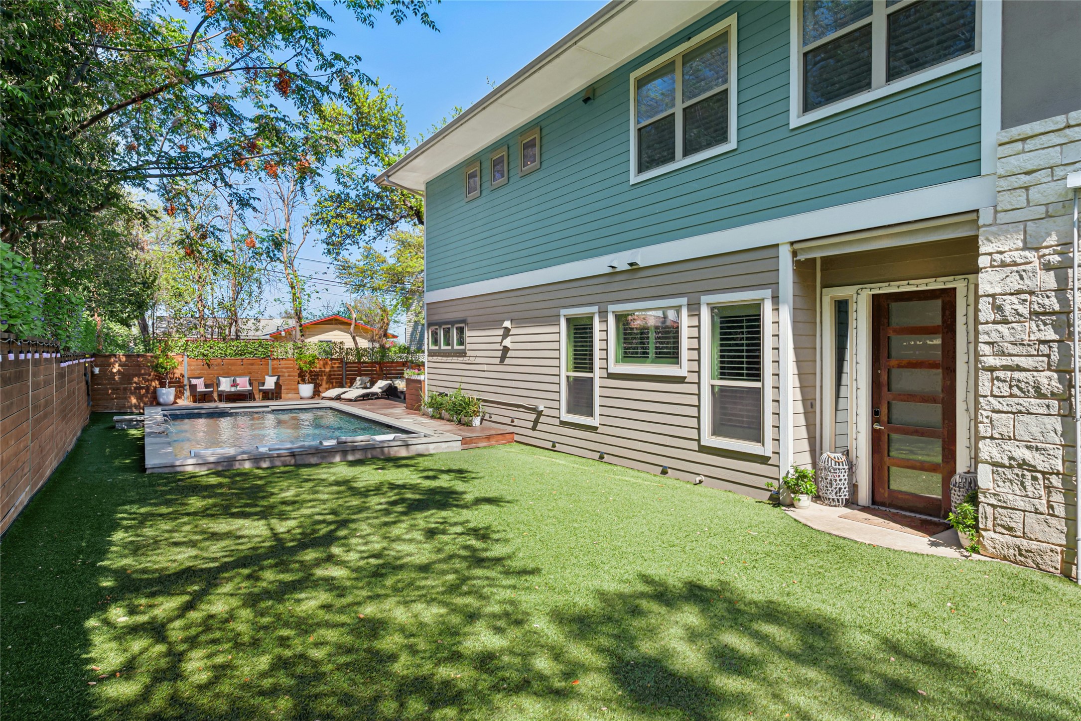 404 West Alpine Road, Unit 17 Austin, TX 78704 - Photo 4 of 35 Back of property featuring a fenced backyard and stone siding