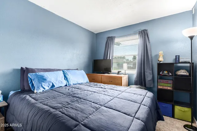 a bedroom with a large bed and a window