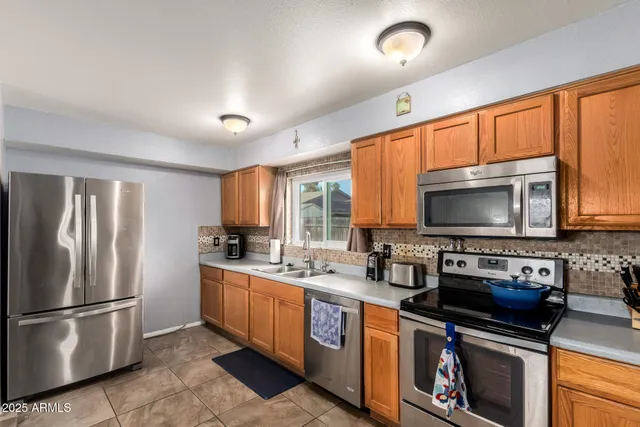 a kitchen with a stove a sink and a refrigerator