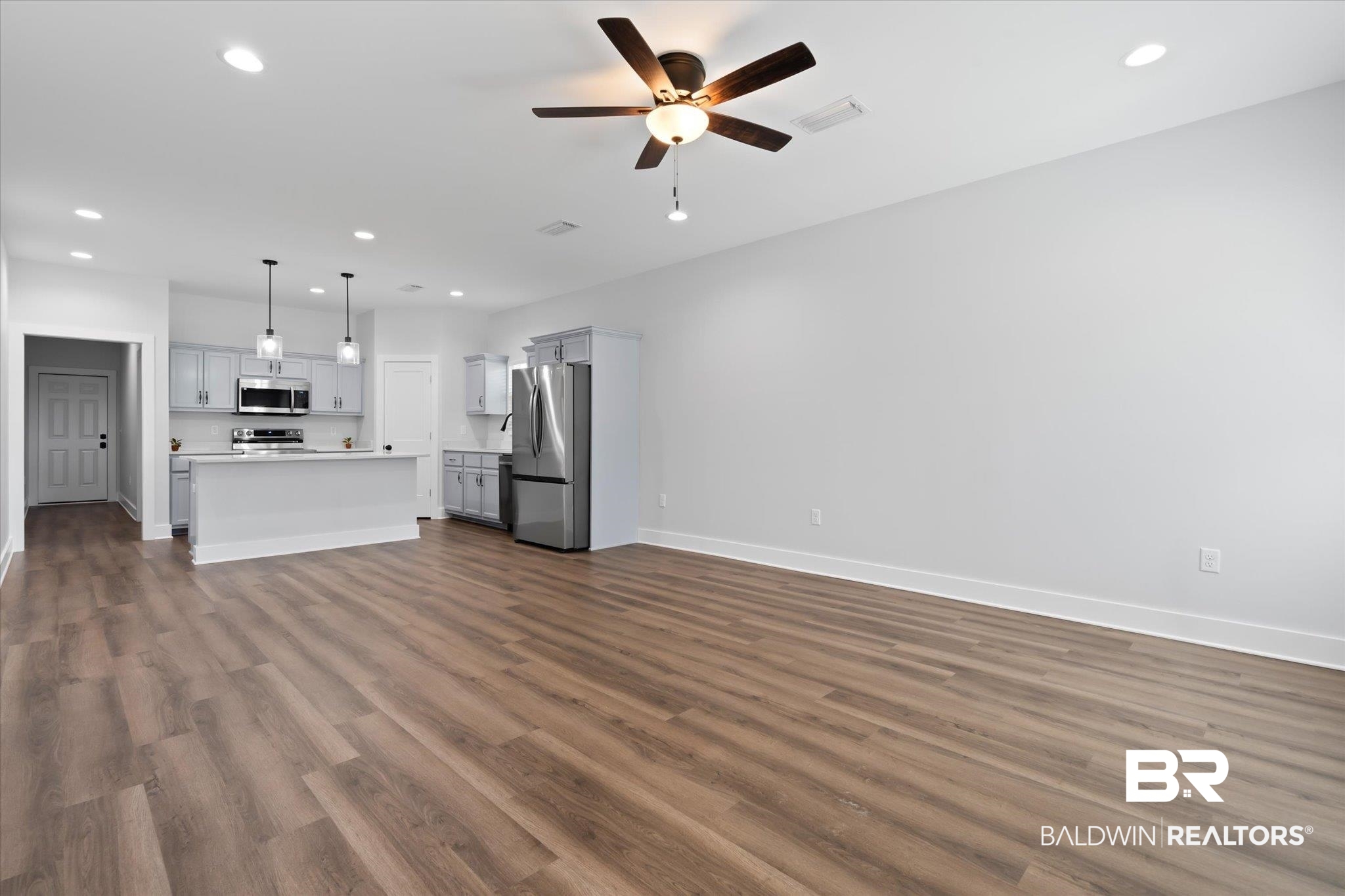 18151 Hoiles Street Robertsdale, AL 36567 - Photo 2 of 23 Unfurnished living room with ceiling fan and dark hardwood / wood-style floors