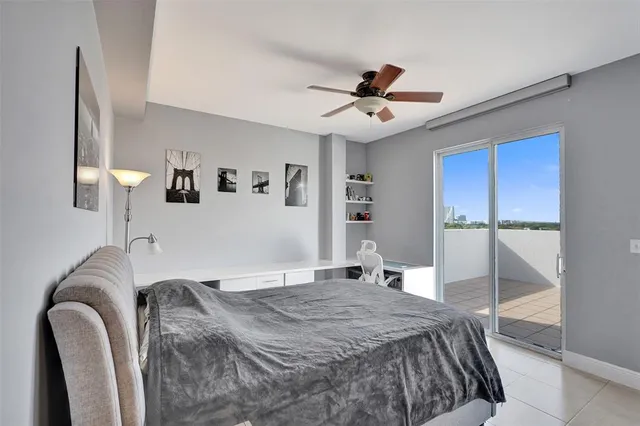 a bedroom with a bed couch and a window