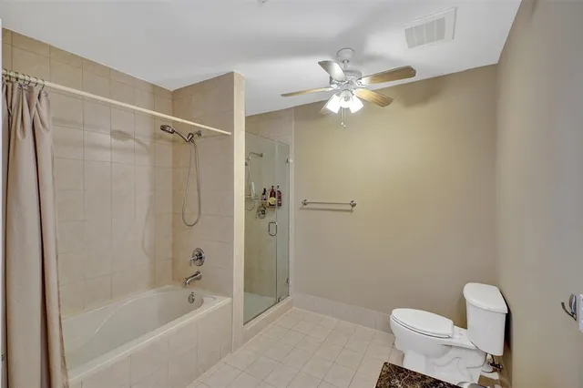 a bathroom with a shower a toilet and a bathtub