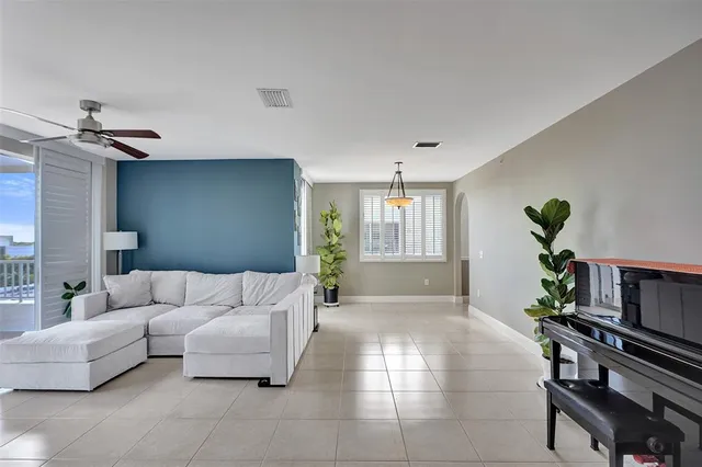 a living room with furniture and a potted plant