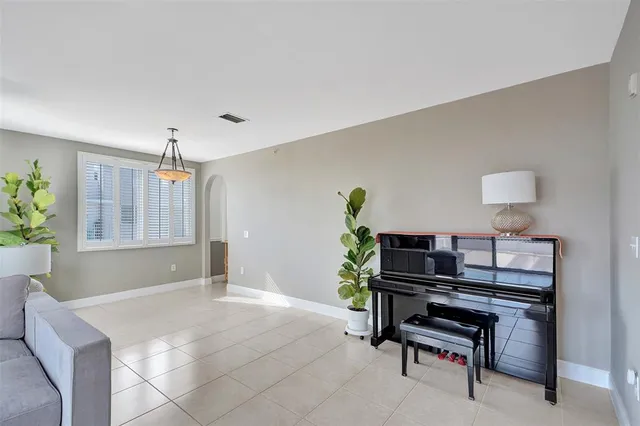 a living room with furniture and a potted plant