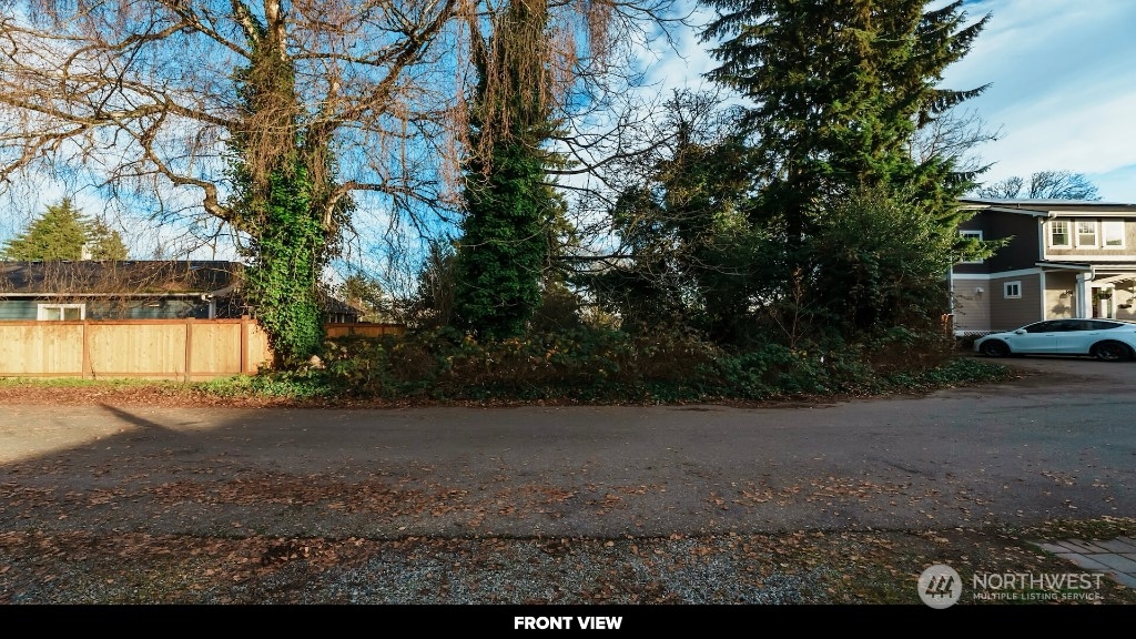 672 Lind Avenue Northwest Renton, WA 98057 - Photo 23 of 25 a view of a yard with plants and trees