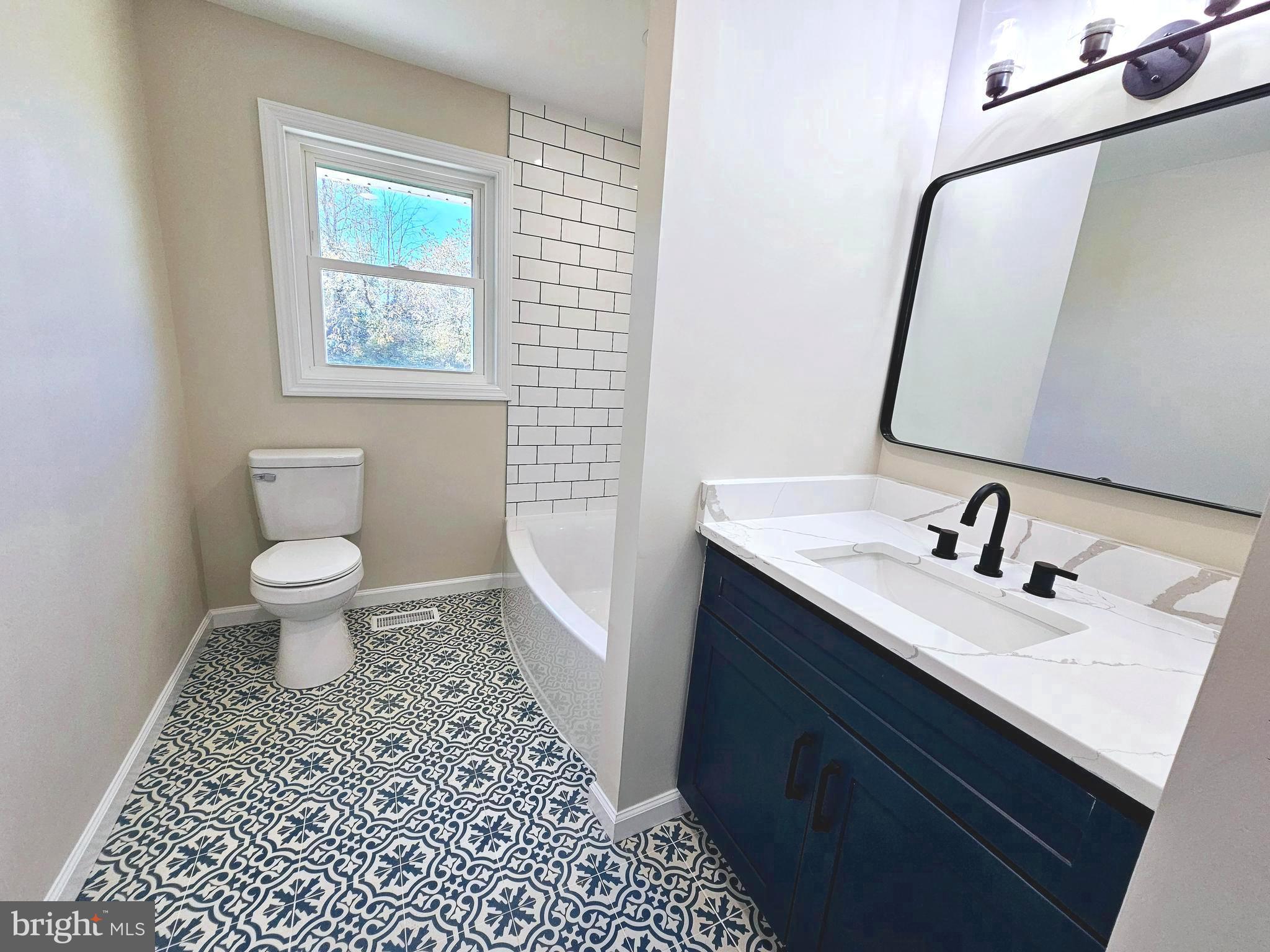 15388 Point Lookout Road St. Inigoes, MD 20684 - Photo 12 of 29 a bathroom with a sink a toilet and a mirror