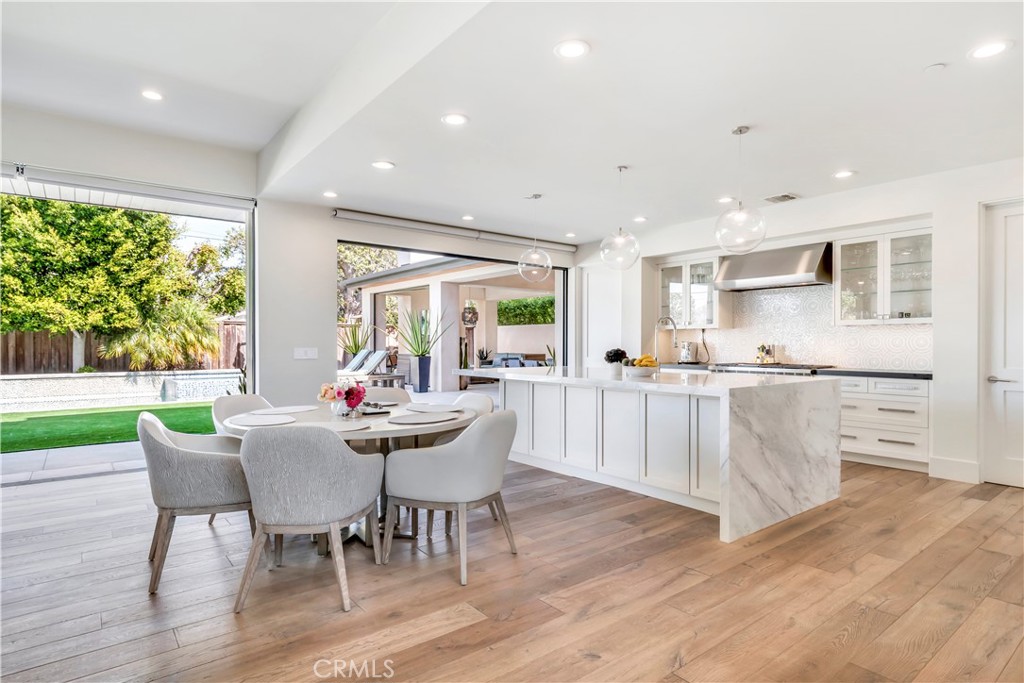 660 Kings Road Newport Beach, CA 92663 - Photo 6 of 41 a view of a dining room with furniture and wooden floor