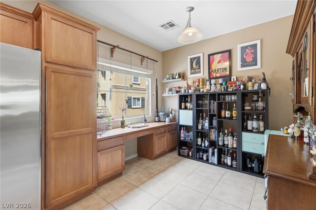 4650 Ranch House Road, Unit 126 North Las Vegas, NV 89031 - Photo 15 of 44 This versatile space features practical built-in cabinetry and durable tile flooring, ideal for a home office or creative area.