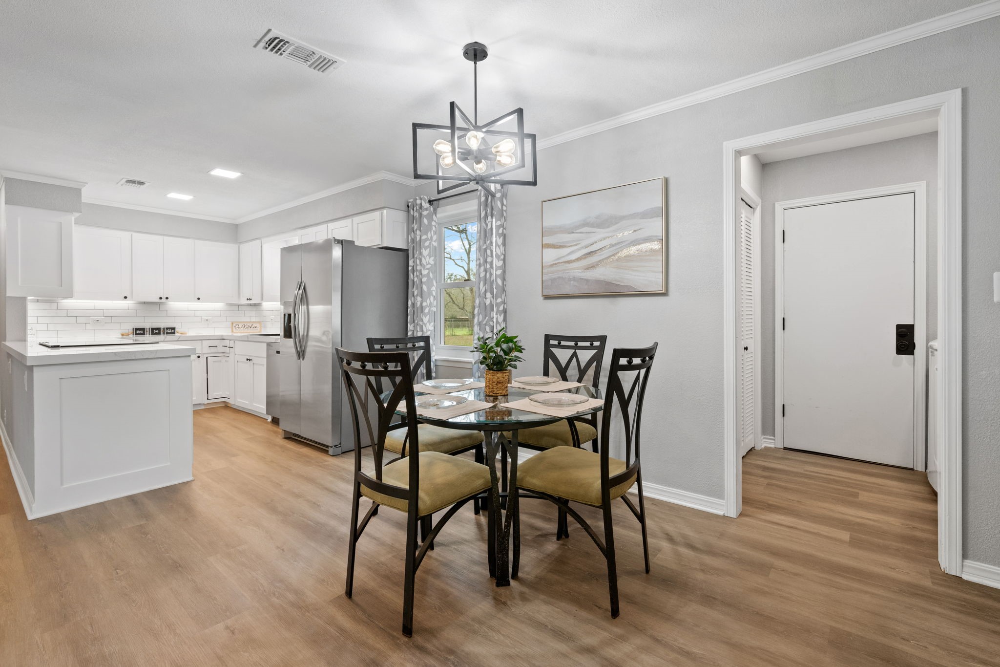 16746 Main Street Splendora, TX 77372 - Photo 11 of 24 a view of a dining room with furniture window and wooden floor