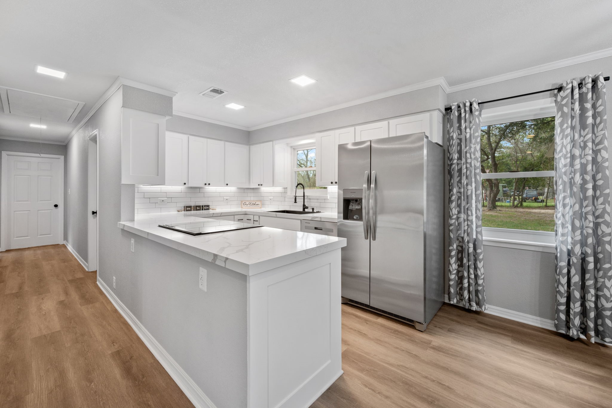 16746 Main Street Splendora, TX 77372 - Photo 12 of 24 a kitchen with a sink a counter top space stainless steel appliances and a window