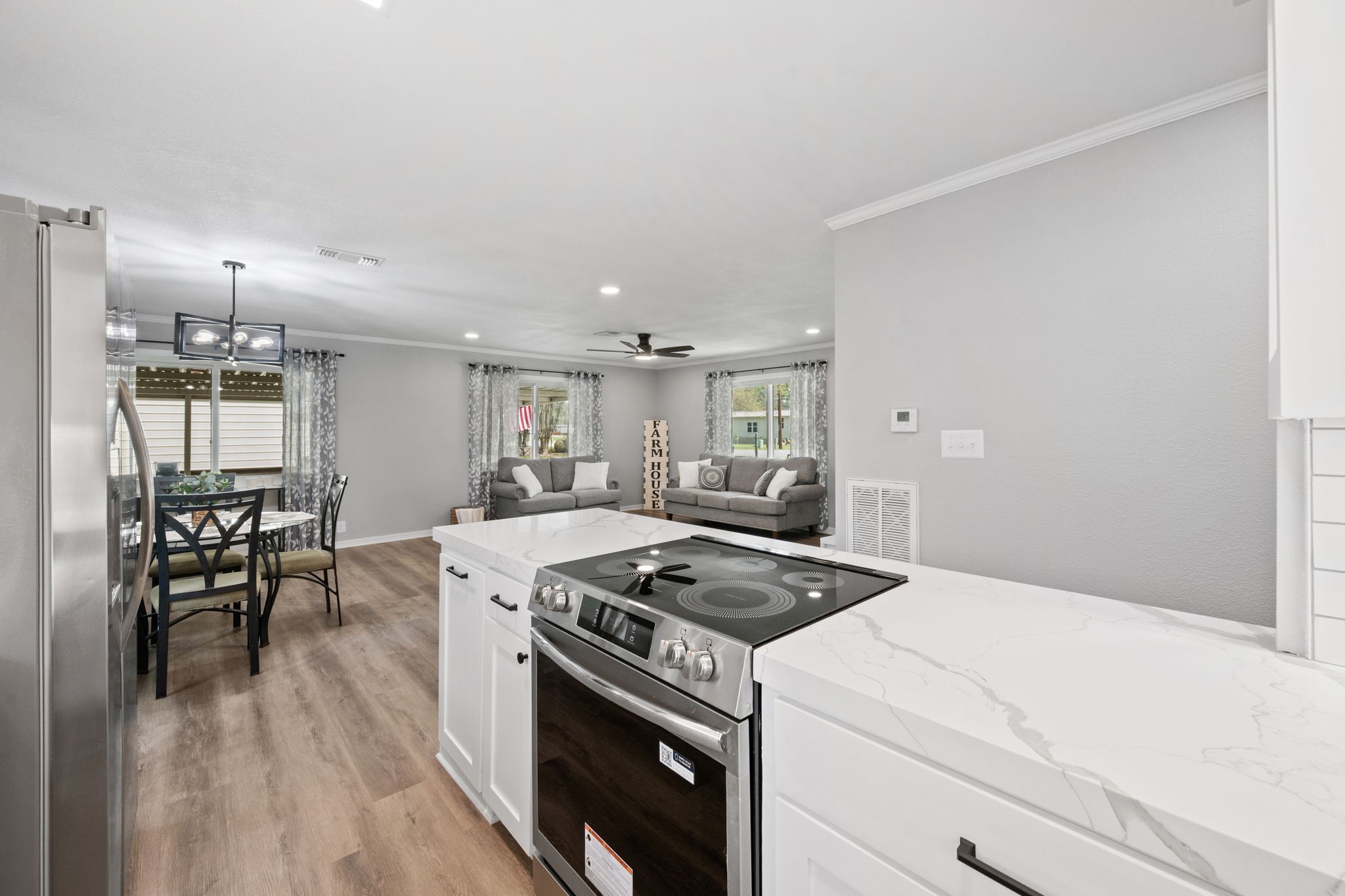 16746 Main Street Splendora, TX 77372 - Photo 13 of 24 a kitchen with a stove a table and chairs
