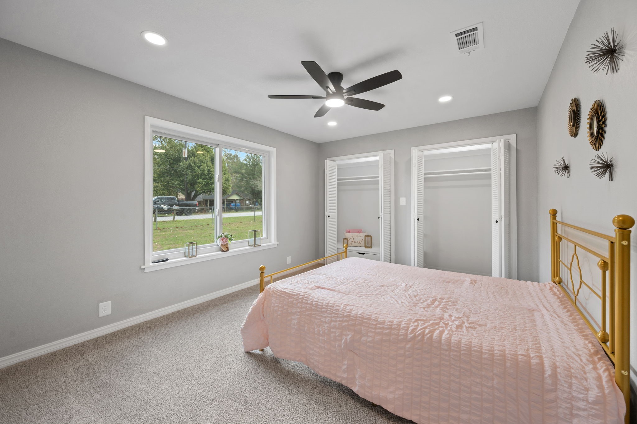 16746 Main Street Splendora, TX 77372 - Photo 18 of 24 a bedroom with a large bed and a chandelier