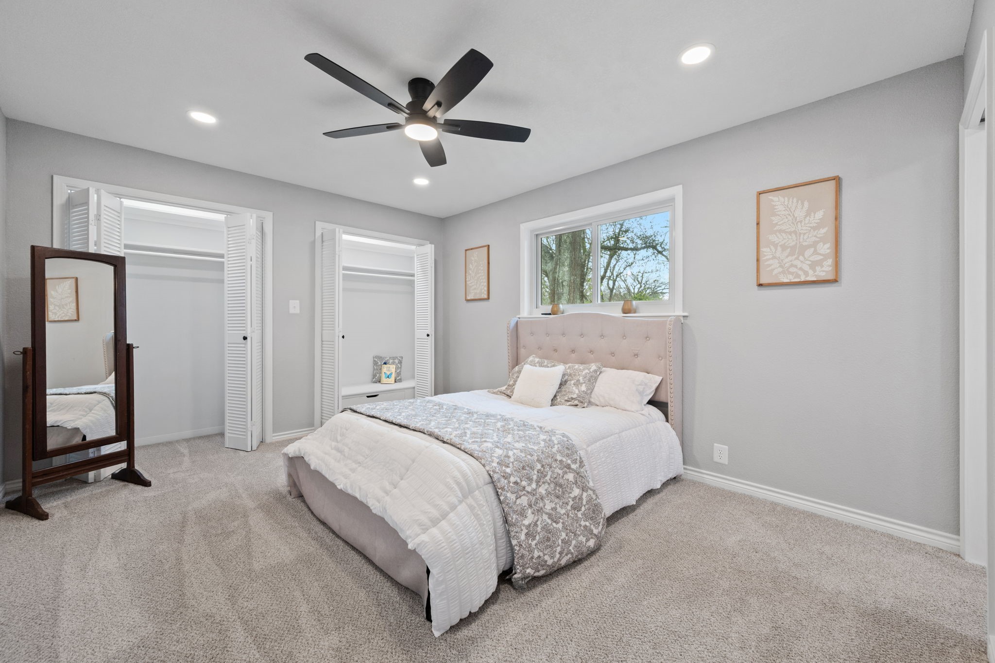16746 Main Street Splendora, TX 77372 - Photo 20 of 24 a spacious bedroom with a large bed and a chandelier