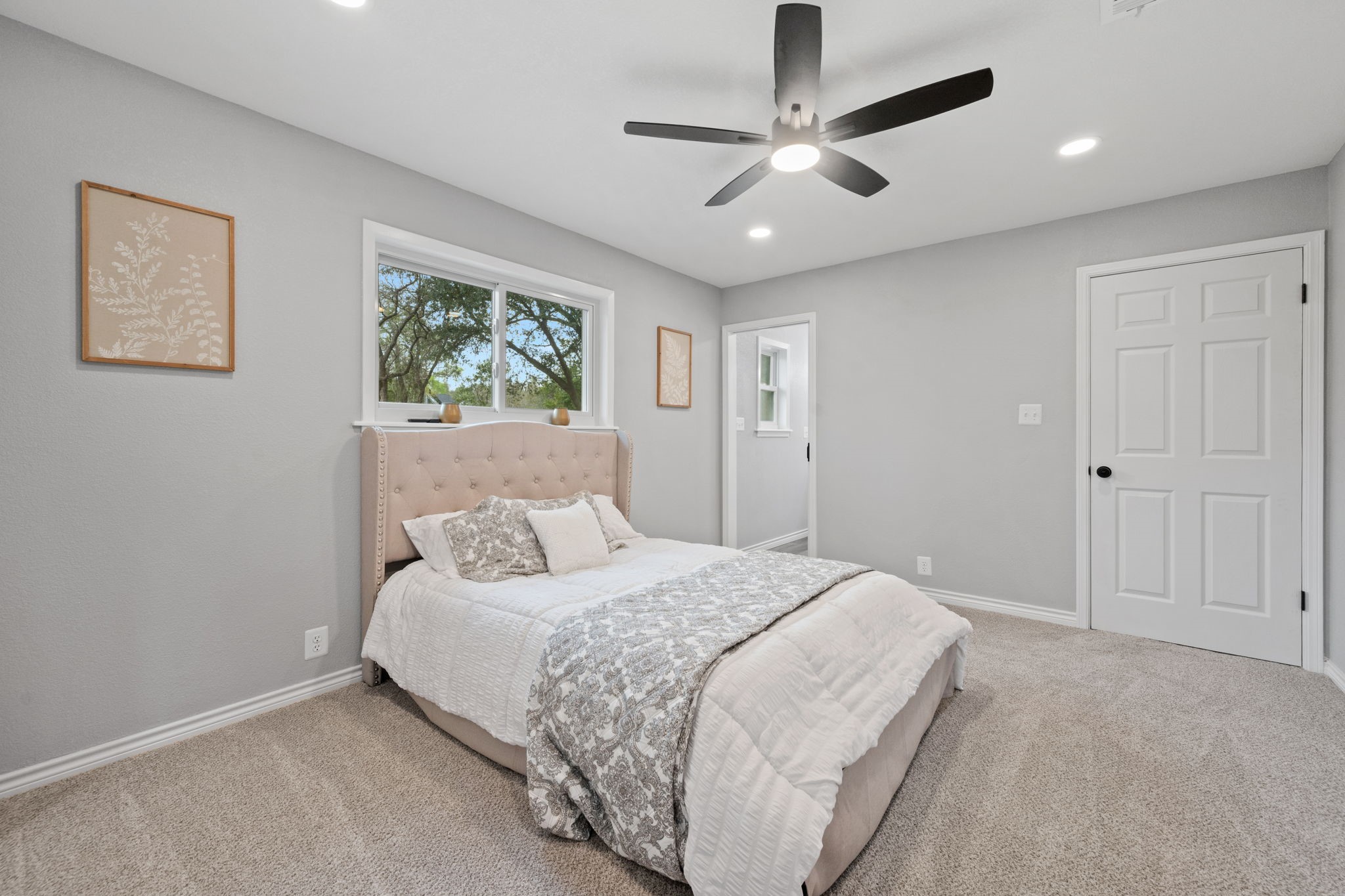 16746 Main Street Splendora, TX 77372 - Photo 21 of 24 a bedroom with a large bed and a chandelier