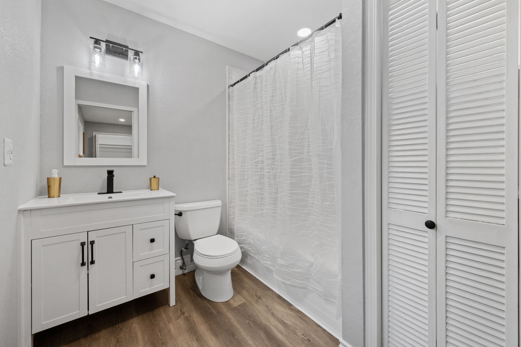 16746 Main Street Splendora, TX 77372 - Photo 22 of 24 a bathroom with a sink a toilet and shower