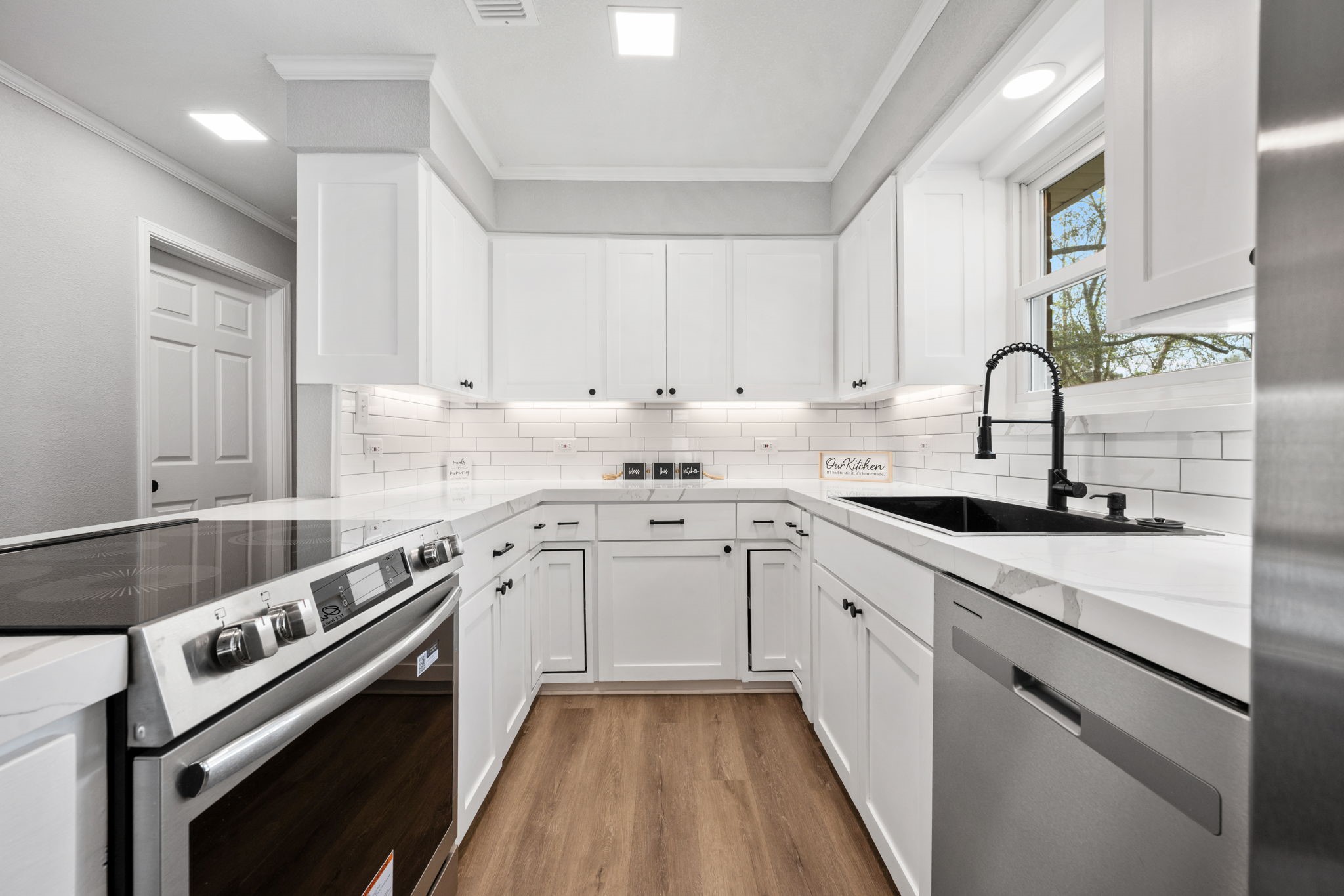 16746 Main Street Splendora, TX 77372 - Photo 3 of 24 a kitchen with a sink stove and cabinets