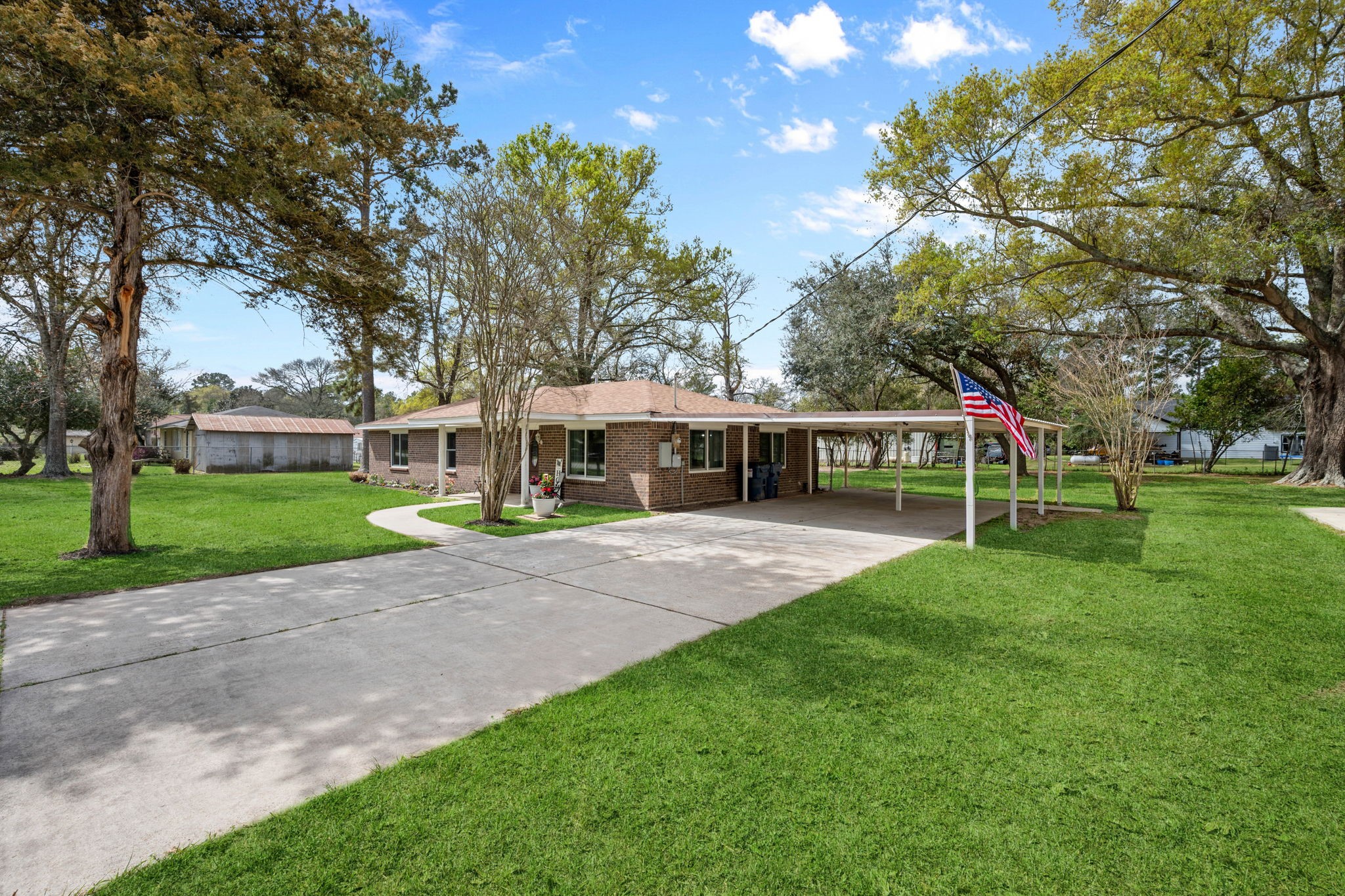16746 Main Street Splendora, TX 77372 - Photo 6 of 24 a view of a yard with a house and large trees